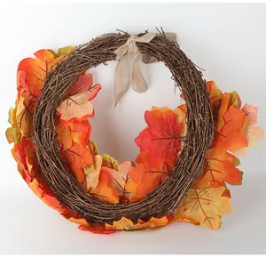 Decorative autumn maple leaf wreath with a burlap bow for Thanksgiving home decor