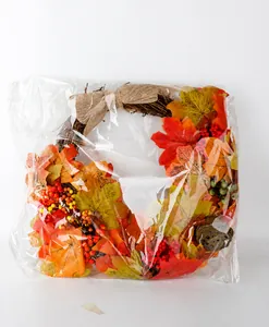 Autumn Thanksgiving maple leaf wreath with berries inside transparent protective packaging