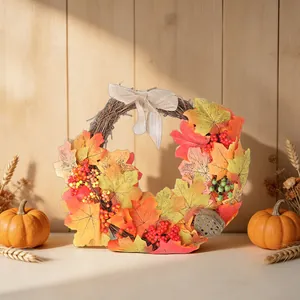 Thanksgiving maple leaf wreath with linen bow and lotus pod for harvest door decor.