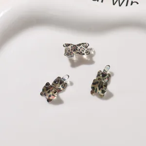 Macro view of leopard print resin cat charms for DIY phone case and earring accessories