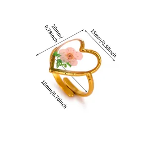 Detailed view of gold heart ring with pink flower and specific size measurements