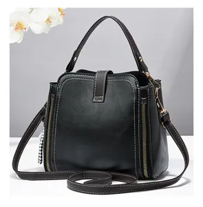 Elegante borsa a secchiello nera da donna con cuciture a contrasto e cerniere laterali dorate