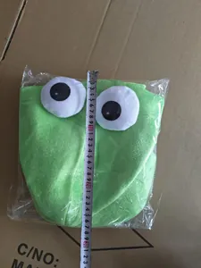 Detailed view of green plush squid hat with measuring tape showing 31cm length