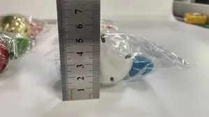 Detail view of Christmas plush doll ornament size measurement with a metal ruler