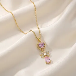 Detailed view of a gold-plated necklace with pink heart and waterdrop zircon pendants.