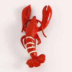 Macro view of a vibrant red lobster brooch with white stripes and enamel finish