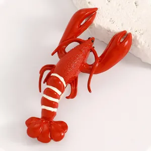 Vibrant red lobster brooch with white stripes and detailed textured body for fashion.