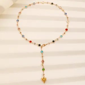 Detail of colorful zircon stainless steel lariat necklace with gold heart pendant