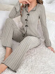 Full view of women's grey ribbed knit two-piece pajama set with delicate black bows
