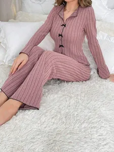 Soft two-piece ribbed knit loungewear set in dusty rose featuring black bow details