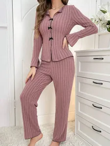 Stylish dusty pink ribbed long-sleeved pajama set with black bow accents for home