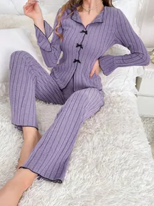 Two-piece purple ribbed pajama set with elegant black bow accents and long sleeves
