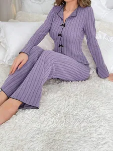 Elegant purple ribbed two-piece pajama set for women featuring delicate black bow accents