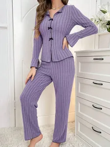 Detail view of the purple ribbed fabric and front butterfly bow accents on pajamas