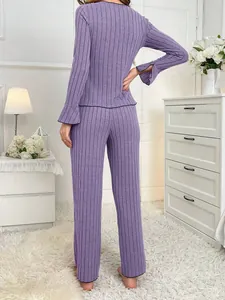 Back view of a cozy purple ribbed two-piece loungewear set for women in home setting