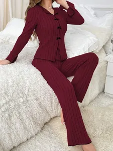 Detail of burgundy ribbed two-piece pajama set featuring delicate bow accents