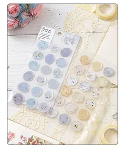Detail view of translucent faux wax seal stickers with elegant floral and gold foil patterns