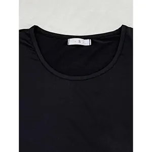 Detailed view of black women's pajama top crew neckline showing white S size tag detail