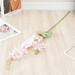 Detailed view of artificial pink Ranunculus branch with multiple flower heads for home decor