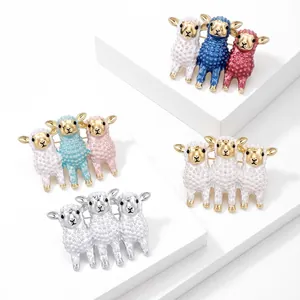 Macro detail of four sheep brooches with three lambs each in various enamel colors