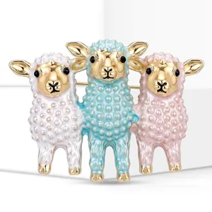 Close-up of a cute three-sheep animal brooch featuring colorful enamel and gold finish