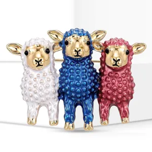 Detail of three colorful enamel sheep brooches with gold-tone accents