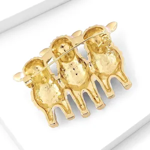 Back view detail of a gold sheep brooch with three joined sheep and pin fastener
