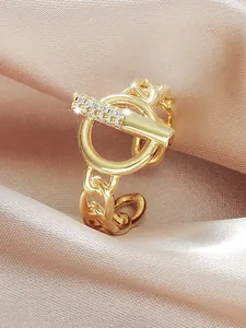 Detailed view of a gold-toned OT buckle ring with sparkling micro-pave cubic zirconia.