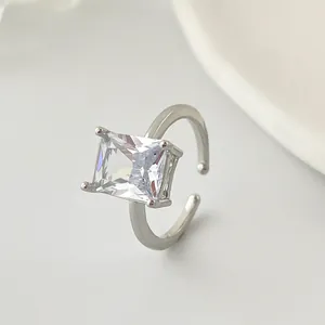 Close-up detail of a silver-toned open ring featuring a large rectangular cubic zirconia