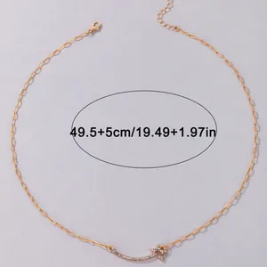 Macro view of gold-tone necklace with star charm showing length measurement 49.5+5 cm
