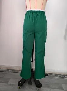 Back view of green wide-leg sports pants with white side stripes on a mannequin