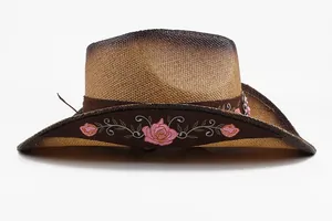 Side view of straw cowboy hat featuring intricate pink floral embroidery detail