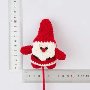 Handmade crochet Santa Claus figure shown with rulers for size and weight detail