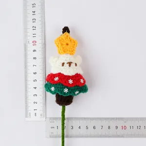 Close-up macro view of handmade crochet Christmas bear decoration with measurement rulers