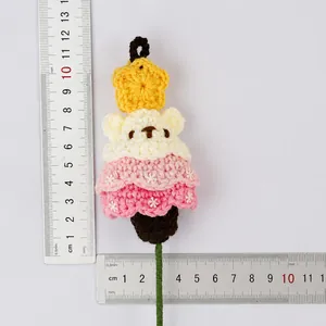 Detailed view of hand-knitted crochet bear and star Christmas bouquet decoration