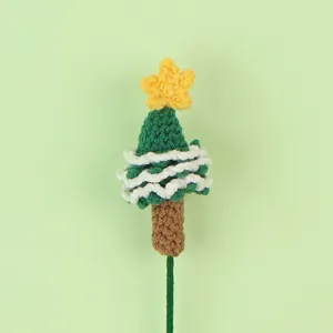 Macro view showing the detailed texture of a handmade green crochet Christmas tree ornament