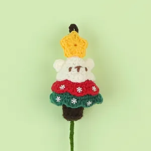 Detail shot of a handcrafted crochet Christmas tree with a cute bear head.