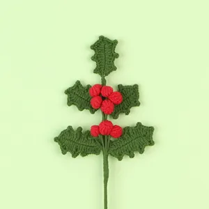 Handmade crochet Christmas holly branch with vibrant red berries and green leaves