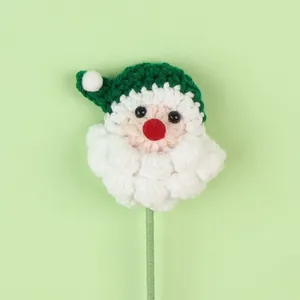 Close-up detail of a handmade crochet Santa Claus ornament for festive Christmas bouquets