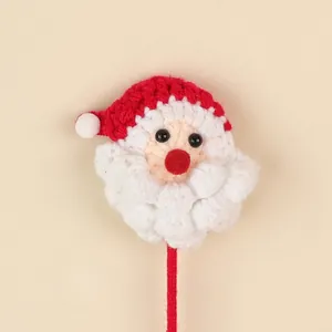 Detail view of a handmade crochet Santa Claus head ornament for holiday bouquets