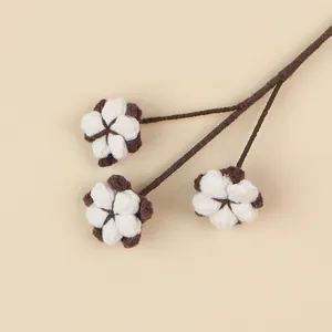 Detailed view of handmade white crochet cotton flower branch for festive home decor