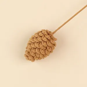 Close-up detail of a handmade brown wool knitted pinecone for Christmas decorations