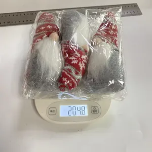 Detail view of 3 Christmas gnomes in a package weighed at 204.8g on a digital scale
