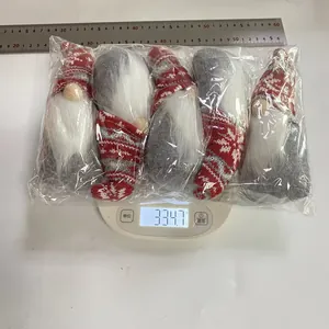 Set of 5 Christmas gnome plush dolls on a digital scale showing weight of 334.7g