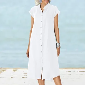 Detail of white linen button-down shirt dress with stand collar and pocket