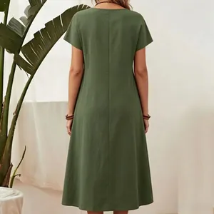 Back view of a forest green short-sleeved cotton linen maxi dress with subtle pleat details