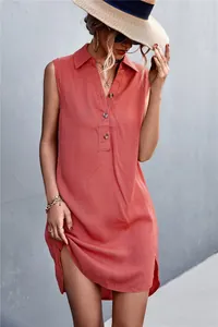 Detail view of coral sleeveless cotton linen dress with V-neck button design and side split