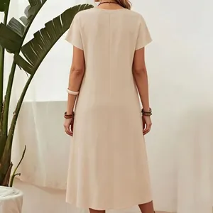 Back view of a plain beige cotton linen short sleeve midi dress for women