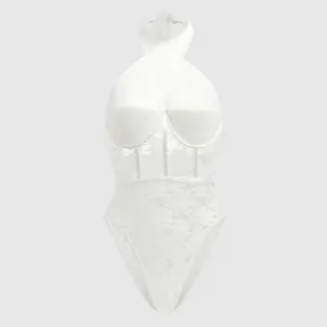 Macro detail view of white lace bodysuit featuring halter neck and underwire corset design.