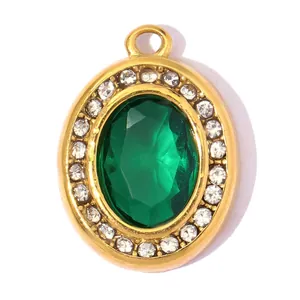 Close-up of elegant oval gold pendant with large faceted emerald green zircon